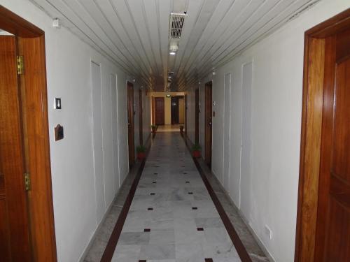 an empty hallway with a long hallway with a corridorngthngthngthngthngthngth at Daspalla Executive Court in Visakhapatnam