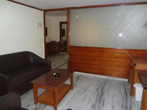 a living room with a couch and a table at Daspalla Executive Court in Visakhapatnam