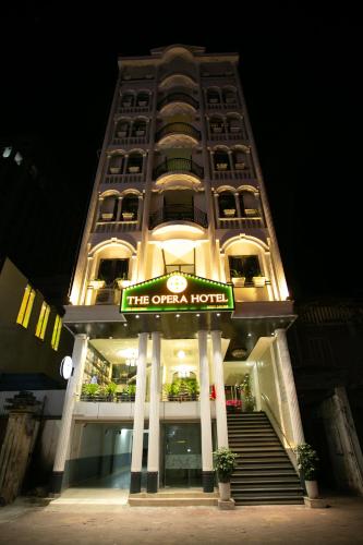 a tall building with a hotel sign in front of it at The Opera Hotel Hải Phòng in Hai Phong