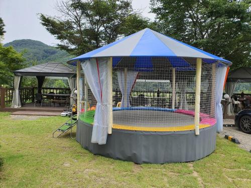 a playset in a gazebo in the grass at Forest of Color Pension in Hongcheon