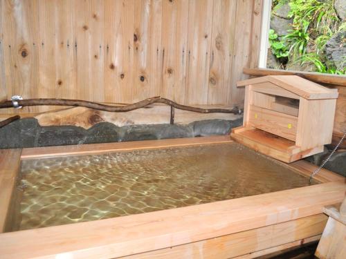 a pool of water in a wooden tub with a bird bath at Kamo-gun - Hotel / Vacation STAY 41220 in Okawa