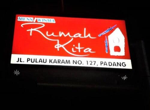 a red sign that says rumbai uttaraji institute at Rumah Kita in Padang