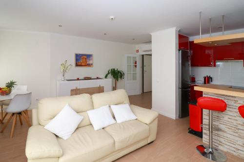 a living room with a couch and a kitchen at Parede Flats in Parede