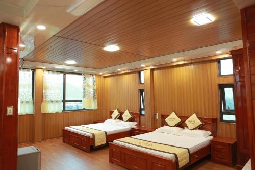 a bedroom with two beds on a boat at Gold Hotel in Cao Bằng