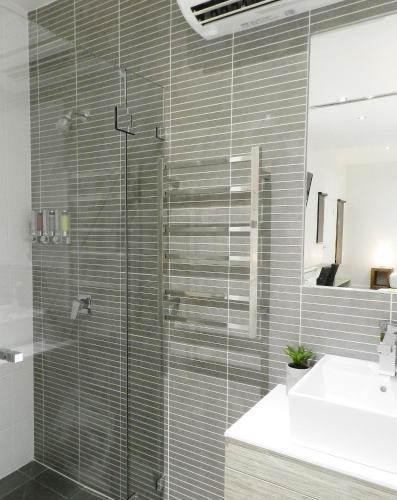 a glass shower in a bathroom with a sink at Copper City Motel in Mount Isa