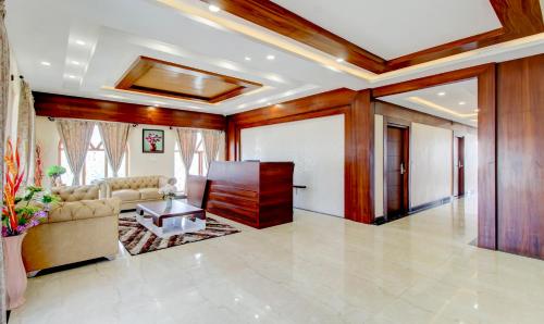 a living room with a couch and a table at Treebo The Meridian in Chikmagalūr
