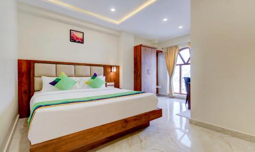 a bedroom with a large bed in a room at Treebo The Meridian in Chikmagalūr