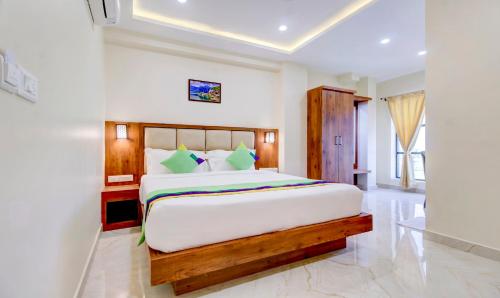 a bedroom with a large bed in a room at Treebo The Meridian in Chikmagalūr