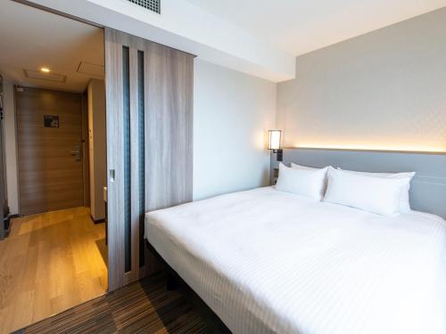 Postel nebo postele na pokoji v ubytování Asakusa Tobu Hotel