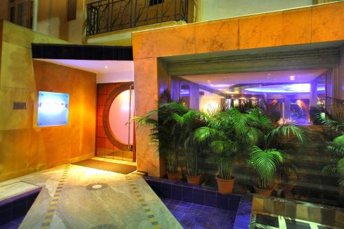 a building with a pool with plants in it at The Sonnet Jamshedpur in Jamshedpur