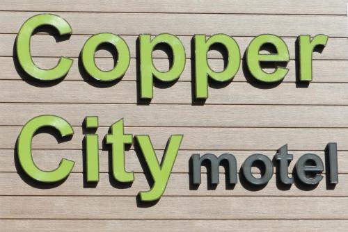a sign on the side of a building at Copper City Motel in Mount Isa