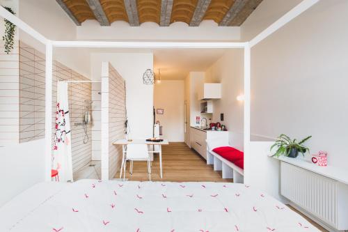 a bedroom with a bed and a dining room at The Hide in Ghent