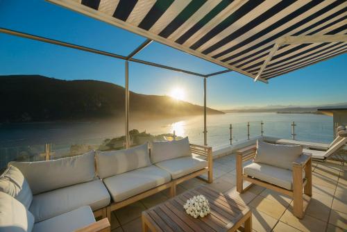 
a view from a balcony overlooking the ocean at Beacon House in Knysna
