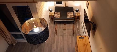 an overhead view of a room with a bed and a table at Duplex Arc en Ciel - Les Deux Alpes in Mont-de-Lans