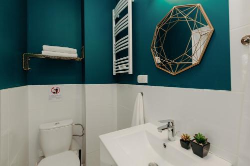 a bathroom with a toilet and a mirror on the wall at L Ajax Airport Bitwy Warszawskiej in Warsaw