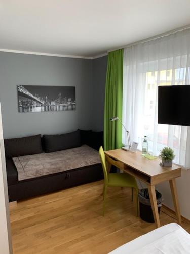 a bedroom with a bed and a desk with a desk at A3 Hotel in Oberhonnefeld-Gierend