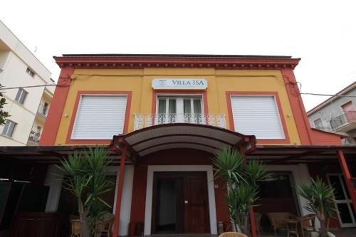 a yellow and orange building with a balcony at HOTEL VILLA ISA in Pescara