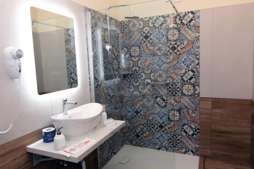 a bathroom with a sink and a shower at HOTEL VILLA ISA in Pescara