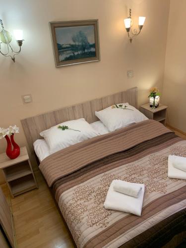 a bedroom with a large bed with two white towels at OW Meduza i Biala Mewa in Międzyzdroje