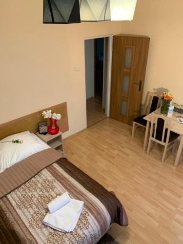 a bedroom with a bed and a table and a dining room at OW Meduza i Biala Mewa in Międzyzdroje