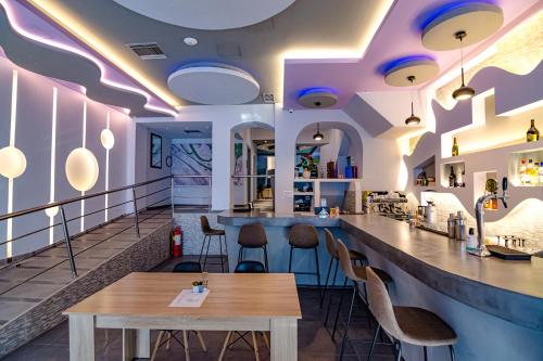 a bar in a restaurant with a table and chairs at N E P center Hotel Rodos in Rhodes Town