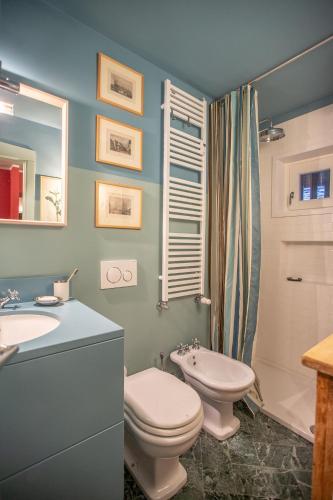 a bathroom with a toilet and a sink at L'Atelier du Temps - PincherleStyle Apartment in Courmayeur