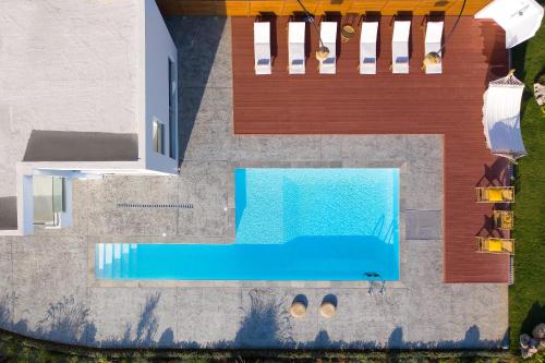 an overhead view of a swimming pool next to a house at Anemos Villas in Lakhania