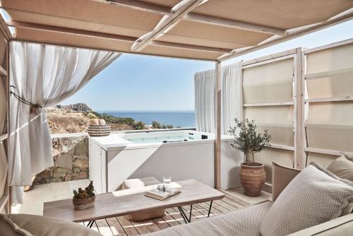 a living room with a view of the ocean at Volcano Luxury Suites Milos - Adults Only in Paliochori