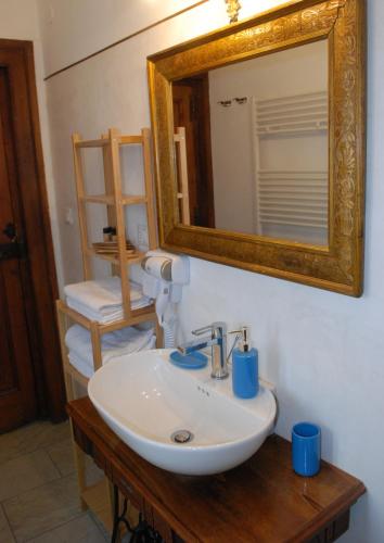 a bathroom with a white sink and a mirror at B&B Donna Livia in Cantalupo nel Sannio