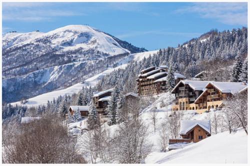 a ski lodge in the snow on a mountain at Vacancéole - Résidence Le Beauregard in La Léchère