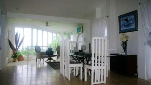 a living room with a table and chairs and a dining room at Thoko-Zani Beach House in KwaDukuza