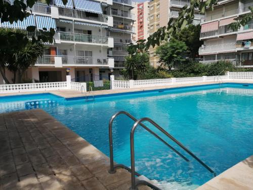a swimming pool in front of some apartment buildings at Sun & Beach Pobla in Puebla de Farnals