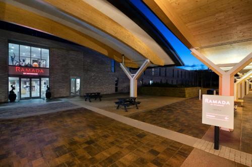 a lobby of a building with a sign in front of it at Ramada by Wyndham Leeds East in Leeds