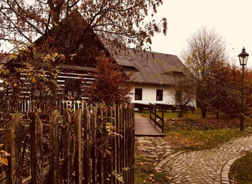 a wooden fence in front of a white house at Penzion Betlém in Hlinsko