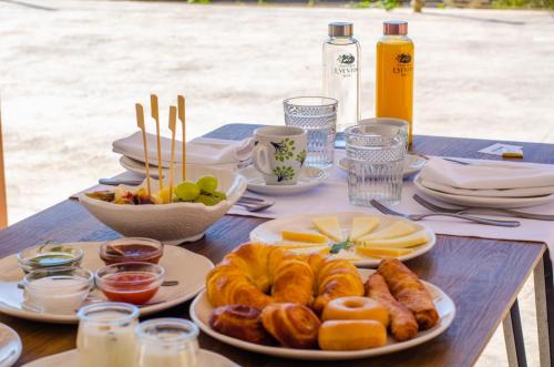 a table with plates of pastries and fruit on it at Hostal Foies de Baix in Relleu