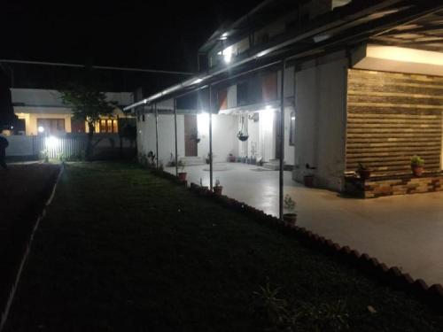 a building with lights on the side of it at night at Nature Villa Kochi in Alwaye