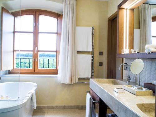 a bathroom with a tub and a sink at Abadia Retuerta LeDomaine in Sardoncillo