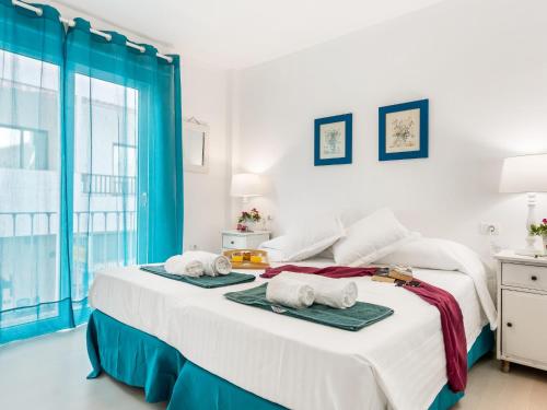 a bedroom with a large bed with towels on it at 205 Los Cristianos by the beach, center, wifi AC in Arona