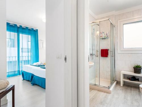 a bedroom with a shower and a bed and a bathroom at 205 Los Cristianos by the beach, center, wifi AC in Arona