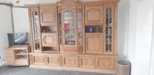 a wooden hutch with a tv in a room at Bei Käthe 