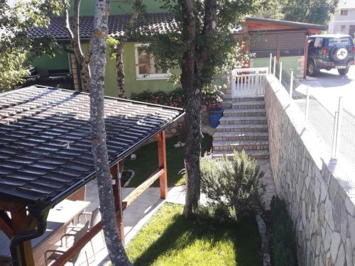 a house with stairs and a retaining wall at Green House Source Vrilo in Tomislavgrad