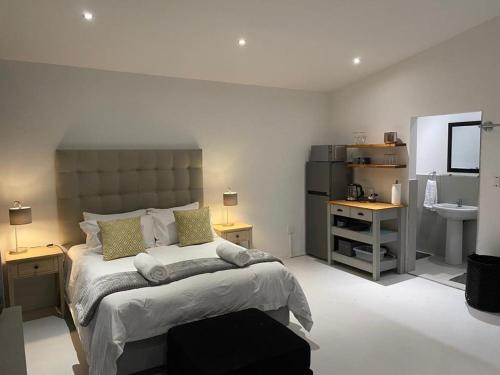 a bedroom with a large bed and a sink at Miles House in George