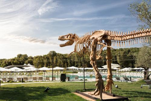 a dinosaur skeleton on display in a park at Apartment Castel in Bale
