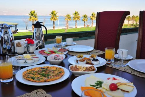 a table with food on it with a view of the ocean at Wellborn Luxury Hotel in Kocaeli