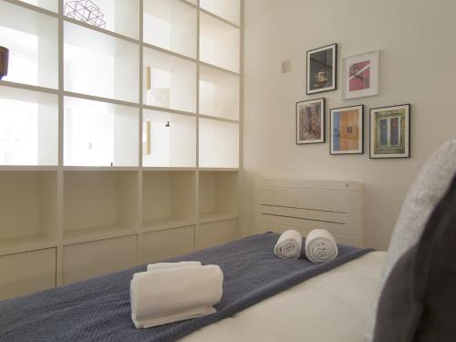 a bedroom with a bed with two towels on it at Chiado bright modern apt with ac elevator in Lisbon