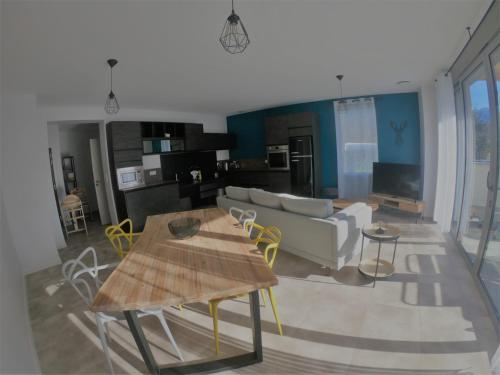 a living room with a couch and a table at L'Argalyde Esprit Pyrénées Wellness & Cycling in Ayzac-Ost