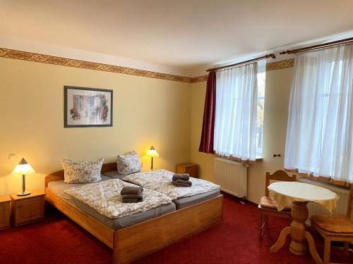 1 dormitorio con cama, mesa y ventanas en Haus Belger en Großziethen