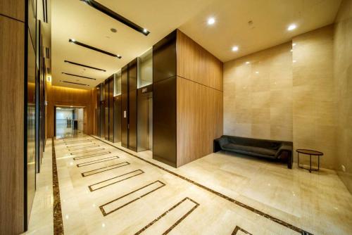 a lobby with a couch in the middle of a building at NETFLIX-Pinnacle PJ, Fantastic City View, 1-6 Guests Designed Duplex Home by Flexihome-MY in Petaling Jaya