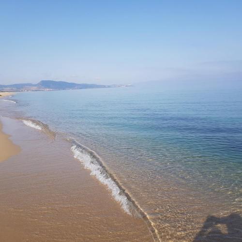 a view of a beach with the ocean at La Casa di Spinosella in Valledoria