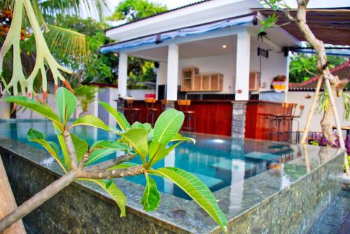 a villa with a swimming pool and a house at Beluran Panorama in Tabanan